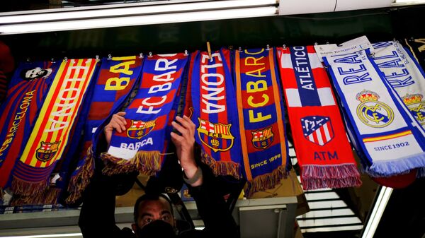 Soccer Football - FC Barcelona, Atletico Madrid and Real Madrid scarves are displayed inside a store at Las Ramblas as twelve of Europe's top football clubs launch a breakaway Super League - Barcelona, Spain - April 19, 2021 - Sputnik International
