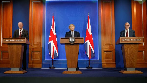 Britain's Chief Medical Officer for England Chris Whitty, Britain's Prime Minister Boris Johnson and Britain's Chief Scientific Adviser Patrick Vallance give an update at a news conference on the coronavirus disease (COVID-19) pandemic, in London, Britain March 29, 2021.  - Sputnik International