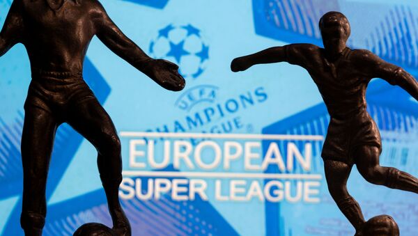 Metal figures of football players are seen in front of the words European Super League and the UEFA Champions League logo in this illustration taken April 20, 2021.  - Sputnik International