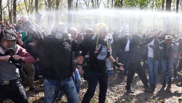 Demonstrators are sprayed with pepper spray during a protest against the government measures to curb the spread of the coronavirus disease (COVID-19), on the day of discussion in the lower house of parliament Bundestag regarding additions for the Infection Protection Act, in Berlin, Germany April 21, 2021 - Sputnik International