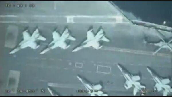 A screenshot from a video allegedly showing a US aircraft carrier took by an IRGC drone in the Persian Gulf - Sputnik International