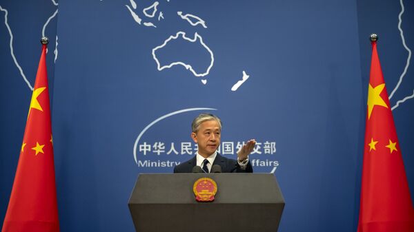 China's Ministry of Foreign Affairs spokesperson Wang Wenbin gestures during a daily briefing at the Ministry of Foreign Affairs in Beijing, Friday, July 24, 2020. - Sputnik International