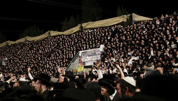 Jewish worshippers sing and dance as they stand on tribunes at the Lag B'Omer event in Mount Meron, northern Israel, April 29, 2021. - Sputnik International
