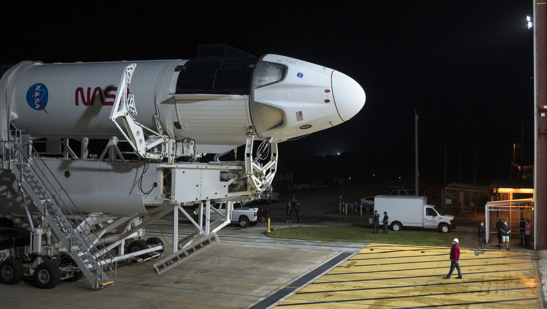 In this Monday, Nov. 9, 2020 photo provided by NASA, a SpaceX Falcon 9 rocket and Crew Dragon capsule is rolled out of the horizontal integration facility at Launch Complex 39A, as preparations continue for a crewed mission at NASA's Kennedy Space Center in Florida.  - Sputnik International, 1920, 04.05.2021