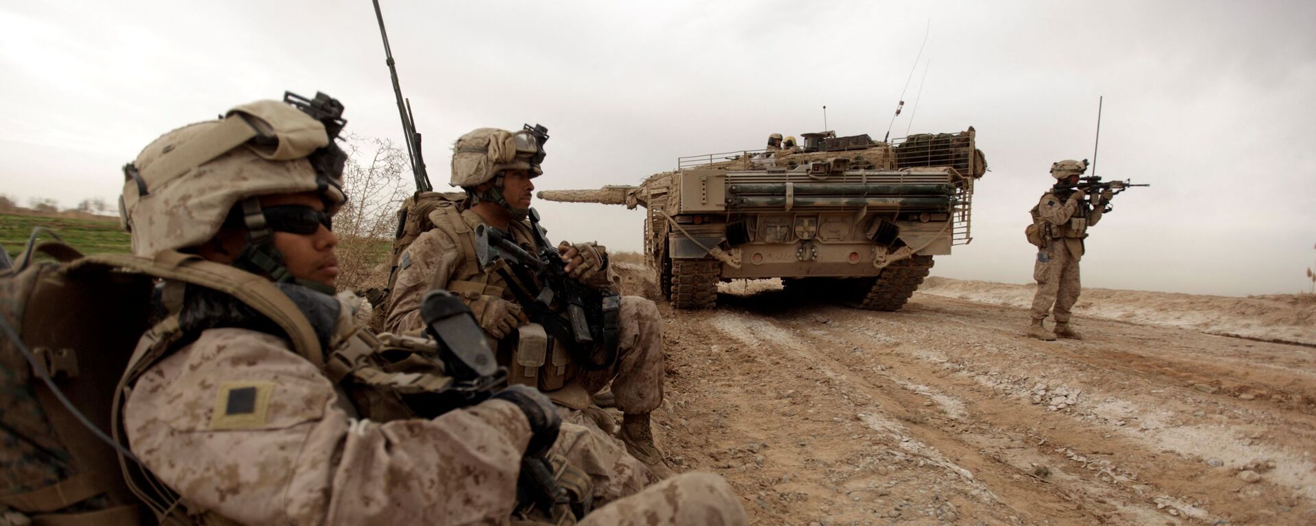 In this file photo taken on February 21, 2010, US marines with 1/3 marine Charlie Company patrol past a Danish army Leopard 2A5EK tank as they clear Improvised Explosive Device (IED)s from a main route in Trikh Nawar on the North Eastern outskirts of Marjah in Afghanistan  - Sputnik International, 1920, 10.05.2021