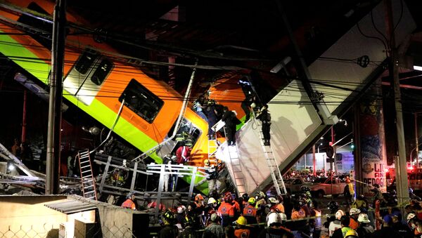 Rescuers work at a site where an overpass for a metro partially collapsed with train cars on it at Olivos station in Mexico City, Mexico May 03, 2021.  - Sputnik International