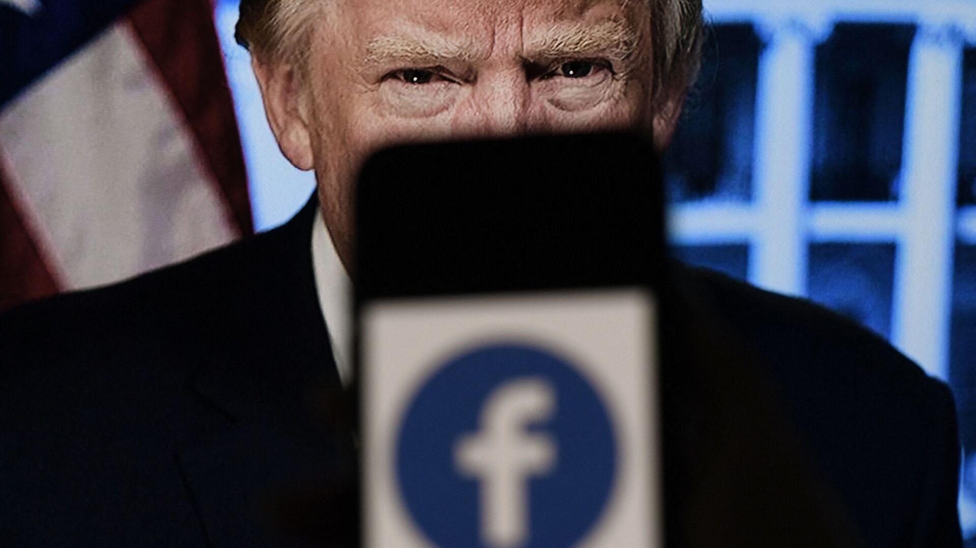 In this photo illustration, a phone screen displays a Facebook logo with the official portrait of former US President Donald Trump on the background, on May 4, 2021, in Arlington, Virginia. - Facebook's independent oversight board was set for a momentous decision on the platform's ban of former US president Donald Trump, as debate swirls on the role of social media in curbing hateful and abusive speech while controlling political discourse. - Sputnik International, 1920, 04.05.2021
