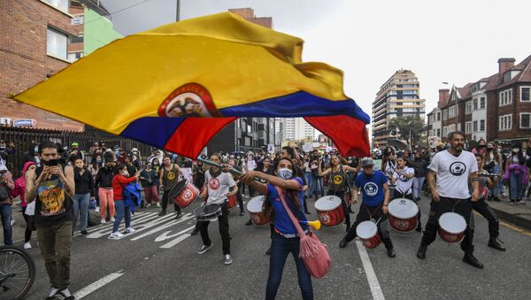 A woman waves a Colombian national flag during a protest against a tax reform proposed by Colombian President Ivan Duque's government in Bogota, on 4 May 2021. The international community on Tuesday decried what the UN described as an excessive use of force by security officers in Colombia after official data showed 19 people killed and 846 injured during anti-government protests. - Sputnik International