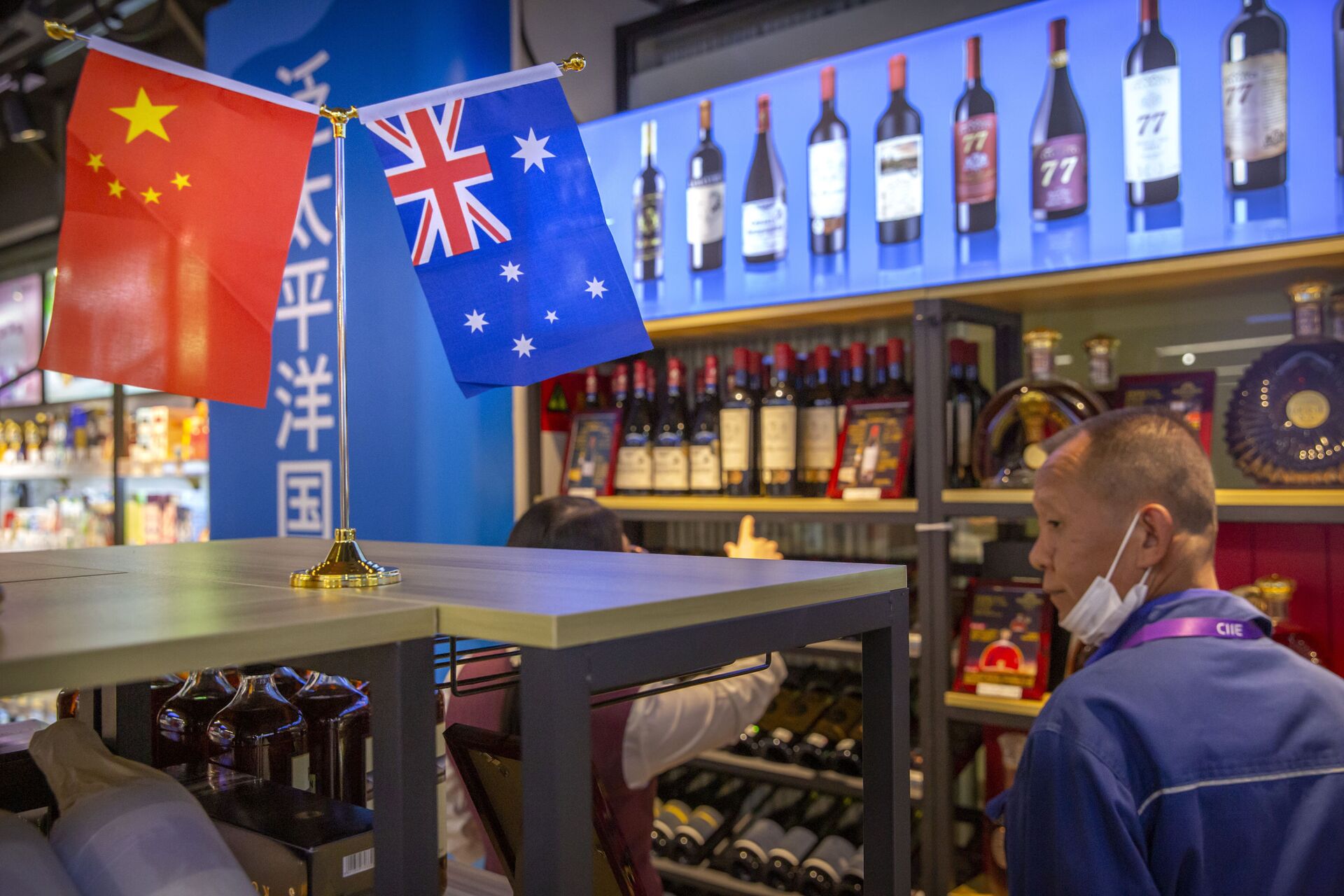 A visitor wearing a face mask to protect against the coronavirus looks at a display of Australian wines at the China International Import Expo (CIIE) in Shanghai on Nov. 5, 2020. China is raising import taxes on Australian wine, stepping up pressure on Australia over disputes including its support for a probe into the origin of the coronavirus. - Sputnik International, 1920, 21.09.2021