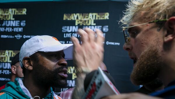 Floyd Mayweather (L) and Jake Paul confront each other during a press conference at Hard Rock Stadium, in Miami Gardens, Florida, on May 6, 2021. - Former world welterweight king Floyd Mayweather said May 4,2021 he will face off against YouTube personality Logan Paul in an exhibition bout at Miami's Hard Rock Stadium on June 6, 2021. - Sputnik International