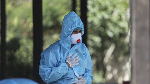 FILE - In this April 25, 2021, file photo, a relative of a person who died of COVID-19 reacts at a crematorium in Jammu, India. Countries fighting new surges of the coronavirus are trying to ensure they aren’t hit by an India-style disaster.  - Sputnik International