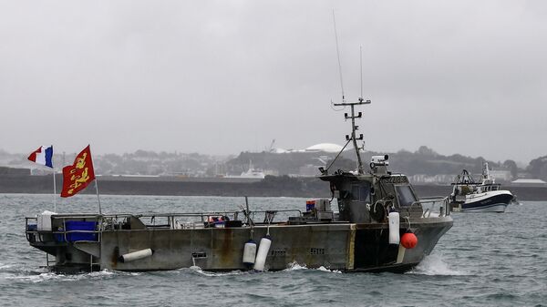 A French fishing boat, one of several, takes part in a protest in front of the port of Saint Helier off the British island of Jersey to draw attention to what they see as unfair restrictions on their ability to fish in UK waters after Brexit, on May 6, 2021. - - Sputnik International
