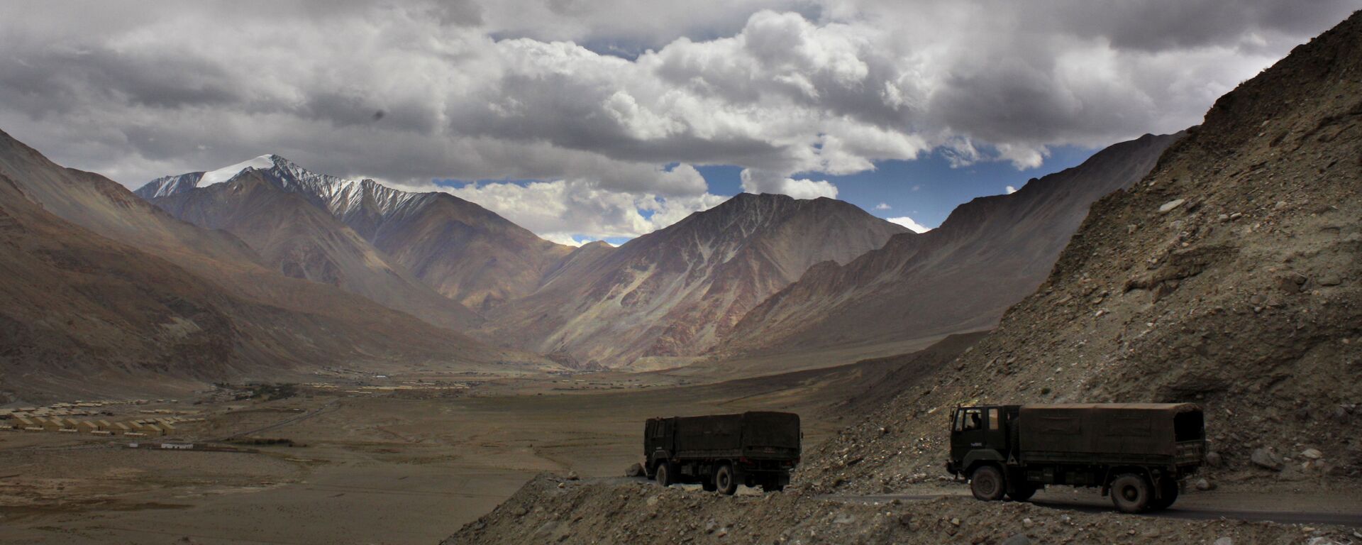 FILE- In this Sept. 14, 2017, file photo, Indian army trucks drive near Pangong Tso lake near the India China border in India's Ladakh area. The Indian army said Saturday, Jan. 9, 2020, that it has apprehended a Chinese soldier in the remote Ladakh region, where the two countries are locked in a monthslong military standoff along their disputed mountain border. An army statement said the Chinese soldier was taken into custody on Friday for transgressing into the Indian side in area South of Pangong Tso lake. (AP Photo/Manish Swarup) - Sputnik International, 1920, 06.08.2021