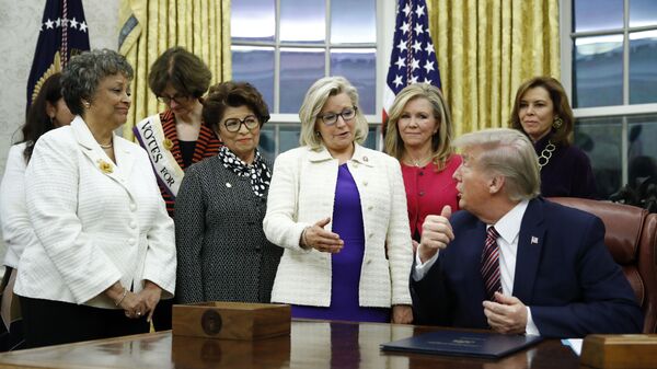 Rep. Liz Cheney, R-Wyo., center, speaks with President Donald Trump during a bill signing ceremony for the Women's Suffrage Centennial Commemorative Coin Act in the Oval Office of the White House, Monday, Nov. 25, 2019, in Washington. - Sputnik International