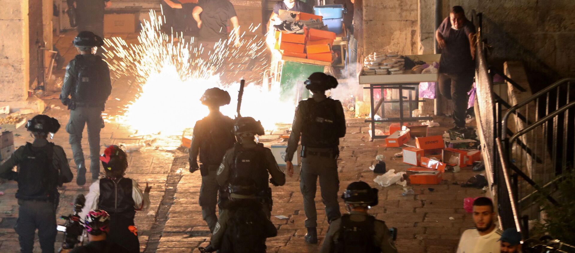 Palestinians react as Israeli police fire a stun grenade during clashes at Damascus Gate on Laylat al-Qadr during the holy month of Ramadan, in Jerusalem's Old City, May 9, 2021 - Sputnik International, 1920, 08.05.2021