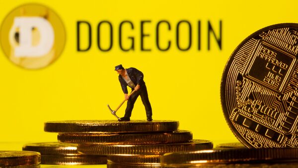 A small toy figure is seen on the cryptocurrency representation with Dogecoin logo in the background in this illustration picture taken, April 20, 2021 - Sputnik International