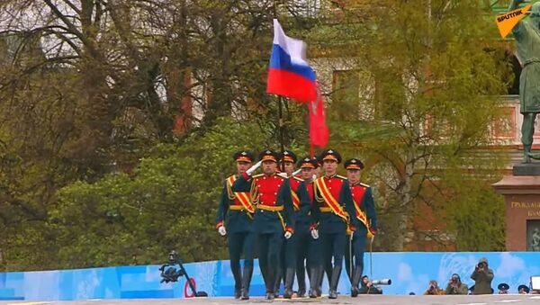 Russia’s national flag and the legendary Banner of Victory are brought onto Red Square.  - Sputnik International