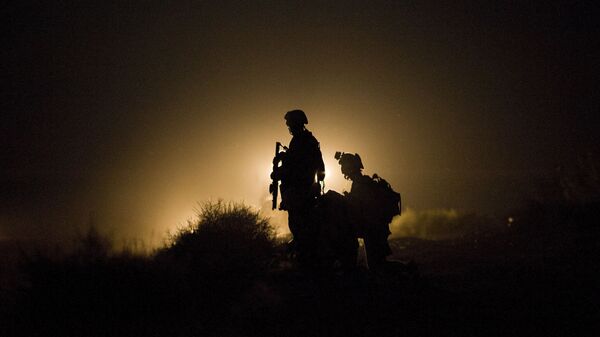In this file photo taken on July 13, 2009, US Marines of 1st Combat Engineering Battalion of 2nd Marine Expeditionary Brigade stand guard as the search goes on for missing marines after an Improvised Explosive Device (IED) blast in Garmsir district of Helmand Province - Sputnik International