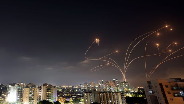 Streaks of light are seen as Israel's Iron Dome anti-missile system intercepts rockets launched from the Gaza Strip towards Israel, as seen from Ashkelon, Israel May 10, 2021. - Sputnik International