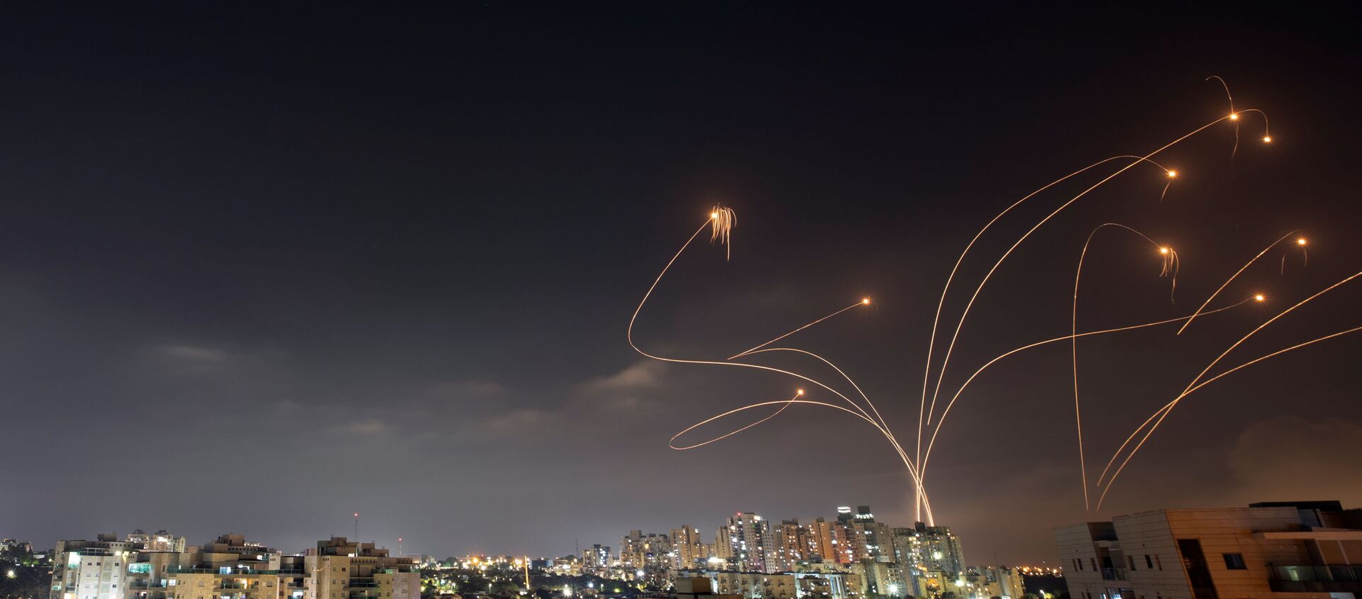 Streaks of light are seen as Israel's Iron Dome anti-missile system intercepts rockets launched from the Gaza Strip towards Israel, as seen from Ashkelon, Israel May 10, 2021. - Sputnik International, 1920