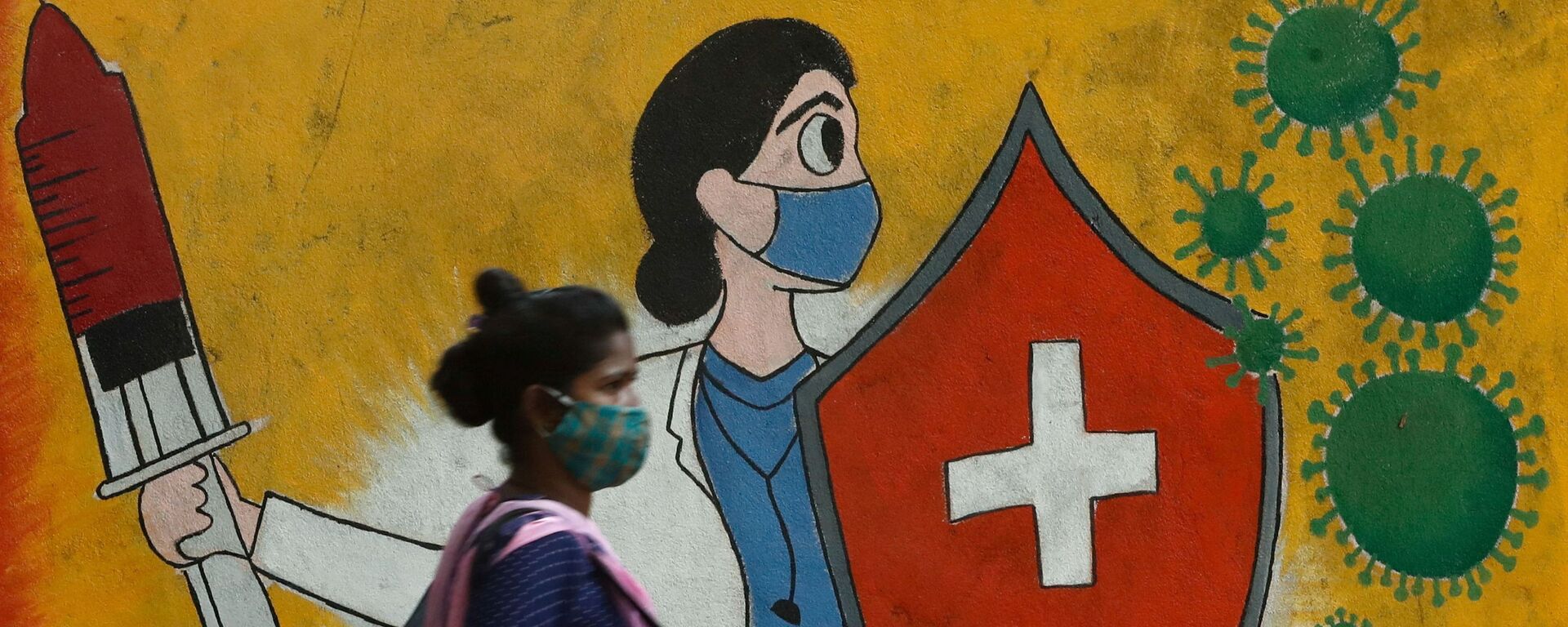 A woman walks past graffiti on a street, amidst the spread of the coronavirus disease (COVID-19) in Mumbai, India, 10 May 2021 - Sputnik International, 1920, 01.06.2021