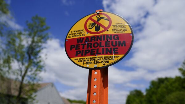 A warning sign is posted along the path of the Colonial Pipeline in Garnet Valley, Pa., Monday, May 10, 2021. Gasoline futures are ticking higher following a cyberextortion attempt on the Colonial Pipeline, a vital U.S. pipeline that carries fuel from the Gulf Coast to the Northeast. - Sputnik International