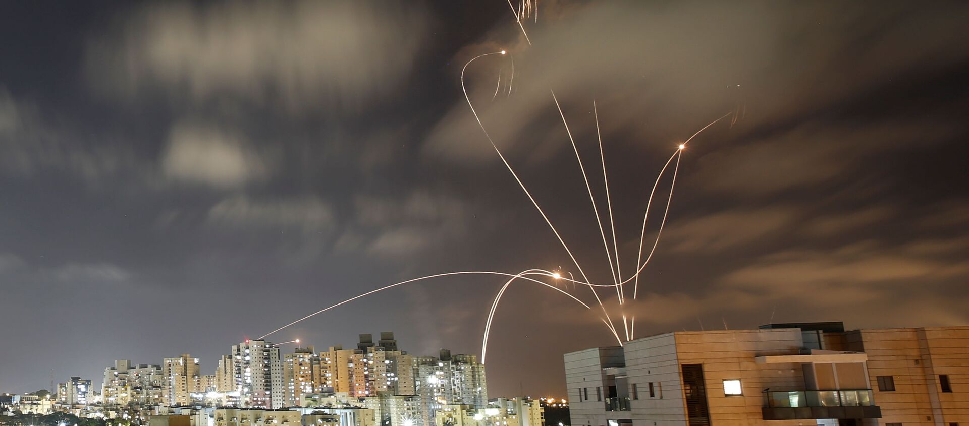 Streaks of light are seen as Israel's Iron Dome anti-missile system intercepts rockets launched from the Gaza Strip towards Israel, as seen from Ashkelon, Israel May 12, 2021. - Sputnik International, 1920, 12.05.2021