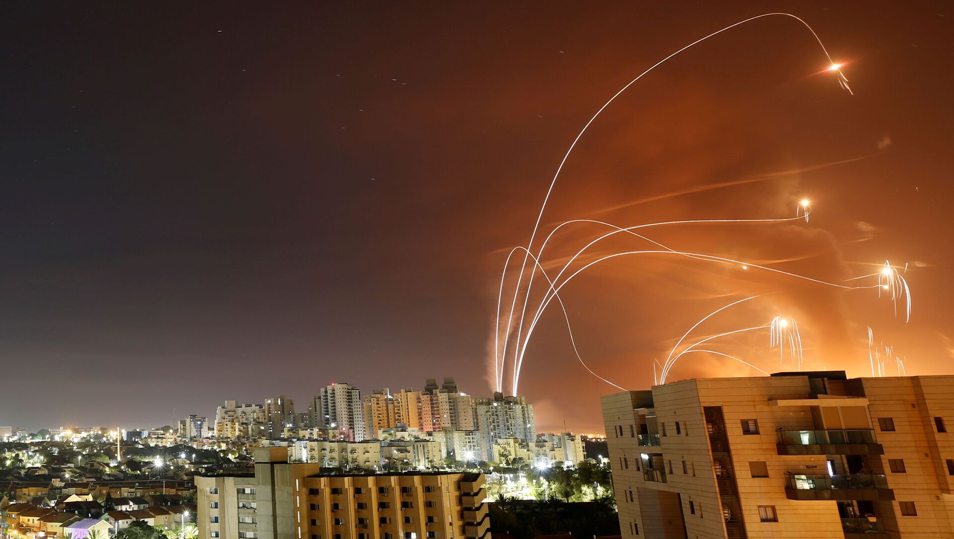 Streaks of light are seen as Israel's Iron Dome anti-missile system intercept rockets launched from the Gaza Strip towards Israel, as seen from Ashkelon, Israel May 12, 2021. - Sputnik International, 1920, 12.05.2021