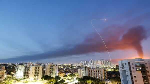 A streak of light is seen as Israel's Iron Dome anti-missile system intercepts rockets launched from the Gaza Strip towards Israel, as seen from Ashkelon, Israel May 12, 2021. - Sputnik International