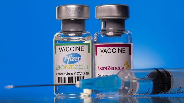  Vials with Pfizer-BioNTech and AstraZeneca coronavirus disease (COVID-19) vaccine labels are seen in this illustration picture taken March 19, 2021 - Sputnik International