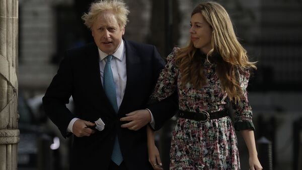 British Prime Minister Boris Johnson arrives at a polling station with his partner Carrie Symonds to cast his vote in local council elections in London, Thursday May 6, 2021 - Sputnik International