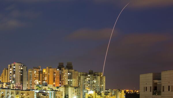 A streak of light is seen as Israel's Iron Dome anti-missile system try to intercept rockets launched from the Gaza Strip towards Israel, as seen from Ashkelon, Israel May 13, 2021. REUTERS/Amir Cohen - Sputnik International