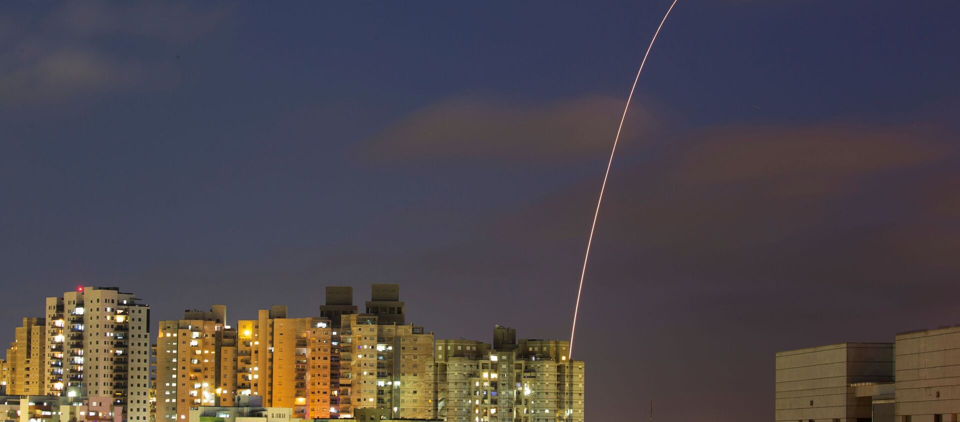 A streak of light is seen as Israel's Iron Dome anti-missile system try to intercept rockets launched from the Gaza Strip towards Israel, as seen from Ashkelon, Israel May 13, 2021. REUTERS/Amir Cohen - Sputnik International, 1920, 15.05.2021