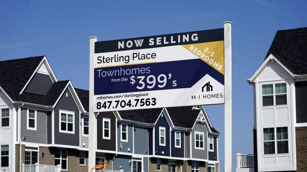 An advertising sign for building land stands in front of a new home construction site in Northbrook, Ill., Sunday, March 21, 2021. - Sputnik International