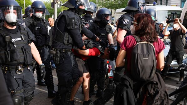 Police officers detain a person after riots during a protest in support of Palestinians, in Berlin, Germany, May 9, 2021. - Sputnik International