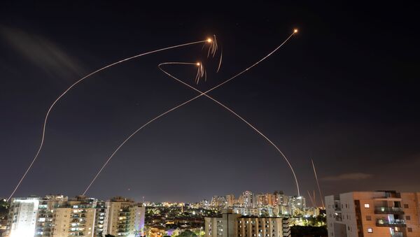 Streaks of light are seen as Israel's Iron Dome anti-missile system intercept rockets launched from the Gaza Strip towards Israel, as seen from Ashkelon, Israel May 13, 2021. - Sputnik International