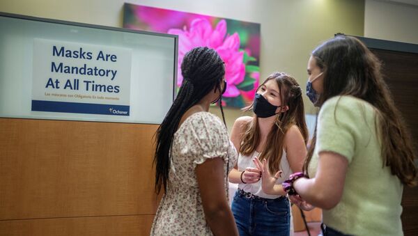 Croix Hill, 15, left Ava Kreutziger, 14 and Lilly Gorman, 15, wait to receive their first dose of the COVID-19 vaccine at the Ochsner Center for Primary Care and Wellness, after the Centers for Disease Control and Prevention recommended the Pfizer vaccine for use in teenagers ages 12 to 15 in New Orleans, Louisiana, U.S., May 13, 2021.  - Sputnik International
