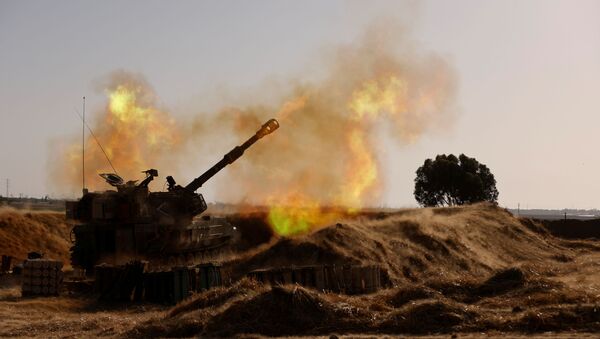 An Israeli mobile artillery unit fires near the border between Israel and the Gaza Strip, May 12, 2021 - Sputnik International