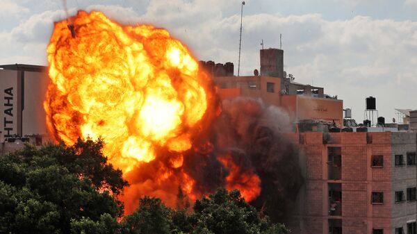 A picture taken on May 13, 2021 shows a ball of fire engulfing the Al-Walid building which was destroyed in an Israeli airstrike on Gaza city early in the morning.  - Sputnik International