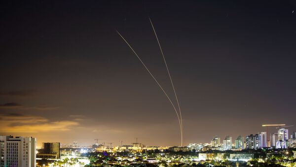 Streaks of light are seen as Israel's Iron Dome anti-missile system aims to intercept rockets launched from the Gaza Strip towards Israel, as seen from Ashkelon, Israel, 14 May 2021. - Sputnik International