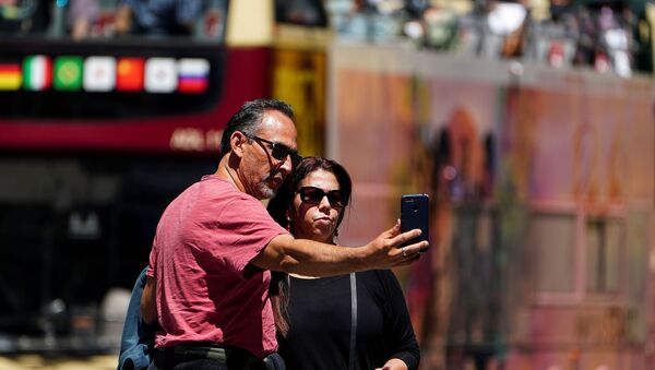 People with no masks pose for photos in Times Square during the coronavirus disease (COVID-19) pandemic in the Manhattan borough of New York City, New York, U.S., May 14, 2021 - Sputnik International