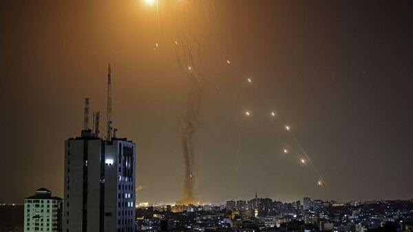 A rocket launched from Gaza city controlled by the Palestinian Hamas movement, is intercepted by Israel's Iron Dome aerial defence system, on May 11, 2021. - Sputnik International