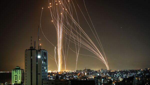 Rockets are launched from Gaza city, controlled by the Palestinian Hamas movement, in response to an Israeli air strike on a 12-storey building in the city, towards the coastal city of Tel Aviv, on 11 May 2021. - Sputnik International