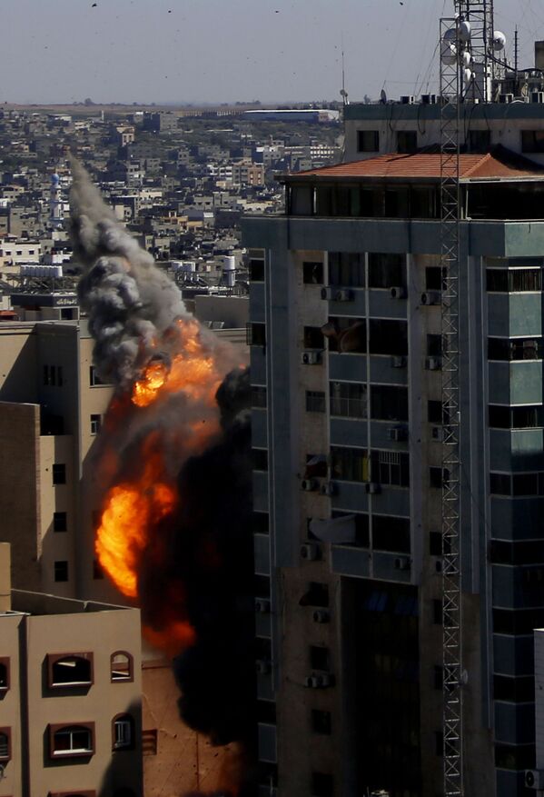 A view of the 13-story building moments after it was hit.   - Sputnik International