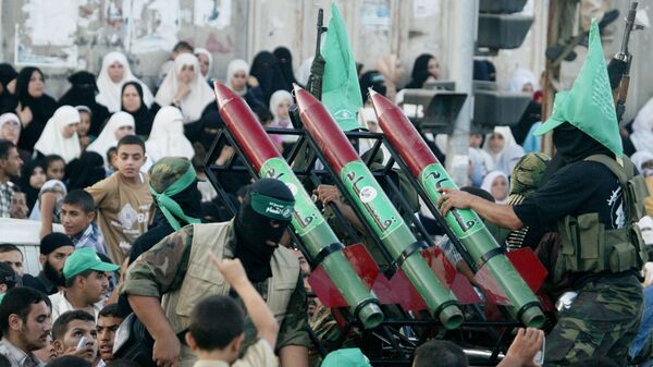Masked Palestinian Hamas militants display their weapons during a parade in Gaza City. File photo. - Sputnik International