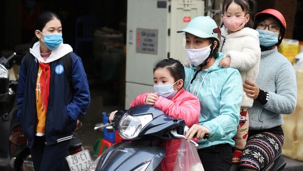 FILE PHOTO: A family wears protective masks as they ride a motorbike in the street amid the coronavirus disease (COVID-19) outbreak in Hanoi, Vietnam, January 29, 2021 - Sputnik International