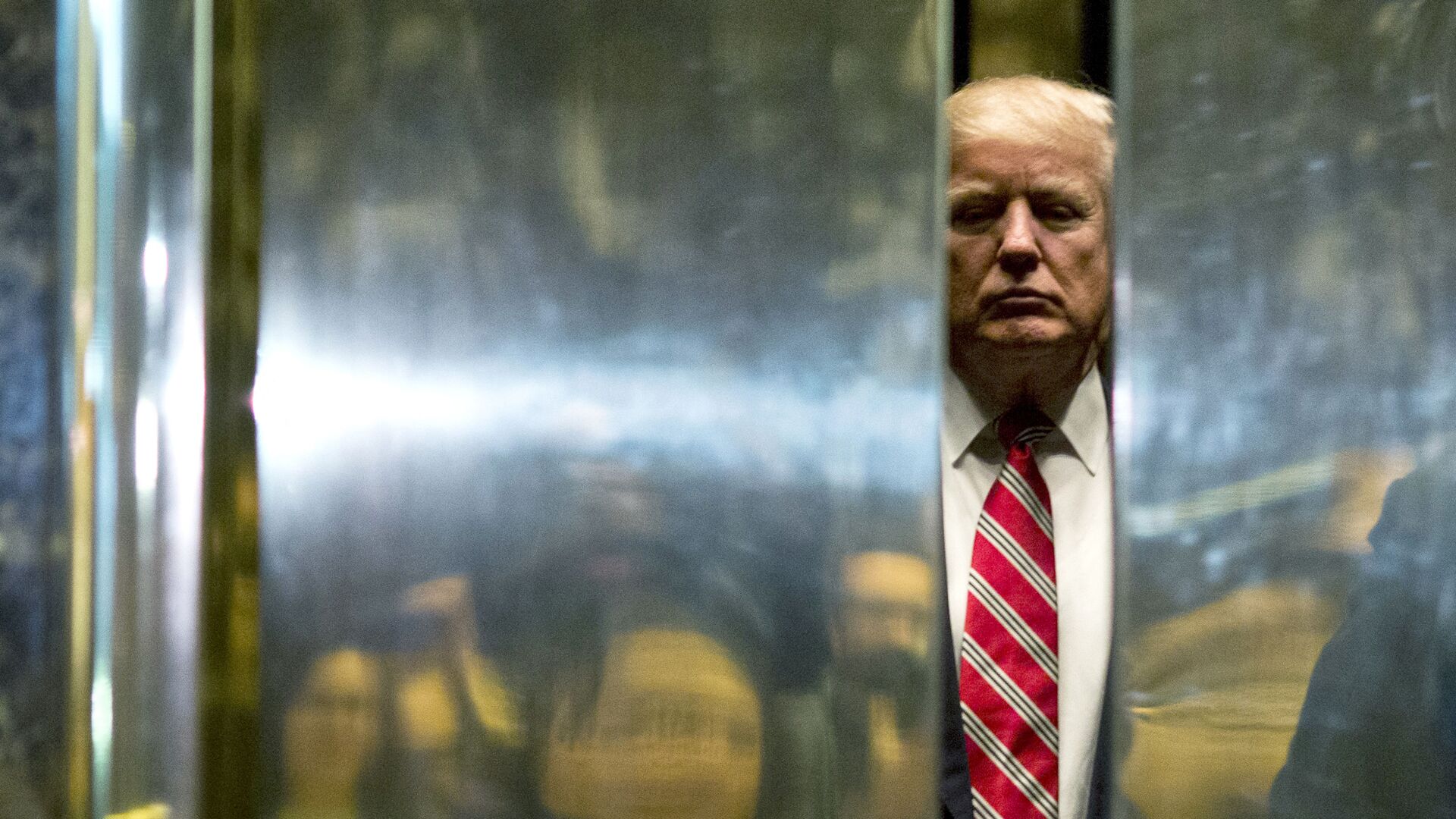 In this file photo taken on January 16, 2017 US President-elect Donald Trump boards the elevator after escorting Martin Luther King III to the lobby after meetings at Trump Tower in New York City. - The Trump Organization is being investigated in a criminal capacity as New York prosecutors advance their probe into former president Donald Trump's business dealings, the state attorney general announced Tuesday. We have informed the Trump Organization that our investigation into the organization is no longer purely civil in nature, a spokesman for Attorney General Letitia James' office said. We are now actively investigating the Trump Organization in a criminal capacity, along with the Manhattan DA. - Sputnik International, 1920, 19.05.2021