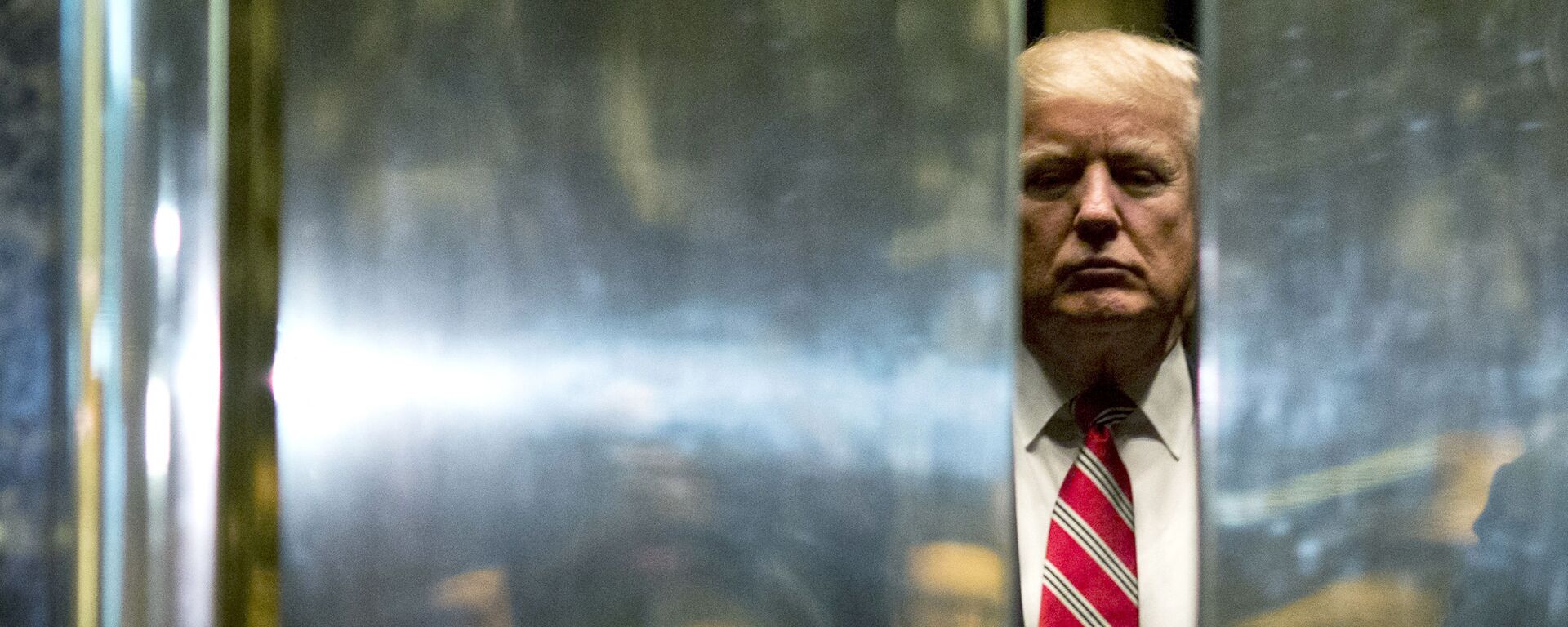 In this file photo taken on January 16, 2017 US President-elect Donald Trump boards the elevator after escorting Martin Luther King III to the lobby after meetings at Trump Tower in New York City. - The Trump Organization is being investigated in a criminal capacity as New York prosecutors advance their probe into former president Donald Trump's business dealings, the state attorney general announced Tuesday. We have informed the Trump Organization that our investigation into the organization is no longer purely civil in nature, a spokesman for Attorney General Letitia James' office said. We are now actively investigating the Trump Organization in a criminal capacity, along with the Manhattan DA. - Sputnik International, 1920, 23.09.2022