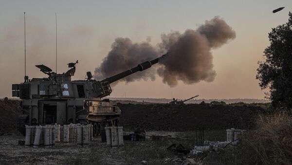 An Israeli artillery unit fires toward targets in Gaza Strip, at the Israeli Gaza border, Tuesday, May 18, 2021 - Sputnik International