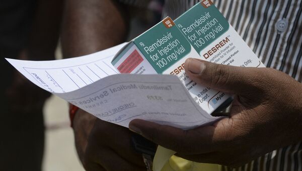 A man holds boxes of Remdesivir, an antiviral drug used to treat Covid-19 coroanavirus symptoms, purchased from government dispensary in Chennai on April 27, 2021 - Sputnik International